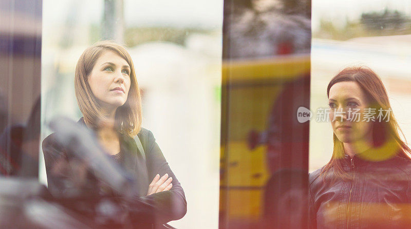 Young women waiting on the bus station